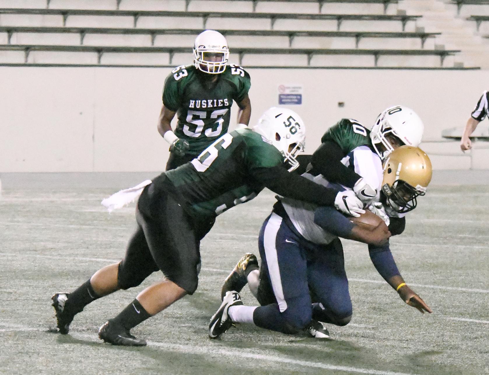 East Los Angeles College freshman defensive lineman Tysean Brown (#56) and freshman linebacker Elijah Quarles (#10) tackle a San Diego Mesa College Olympian as ELAC sophomore offensive lineman Arnulfo Robles (#53) looks on in a 42-23 ELAC win on Sept. 24. (Photo by DeeDee Jackson)