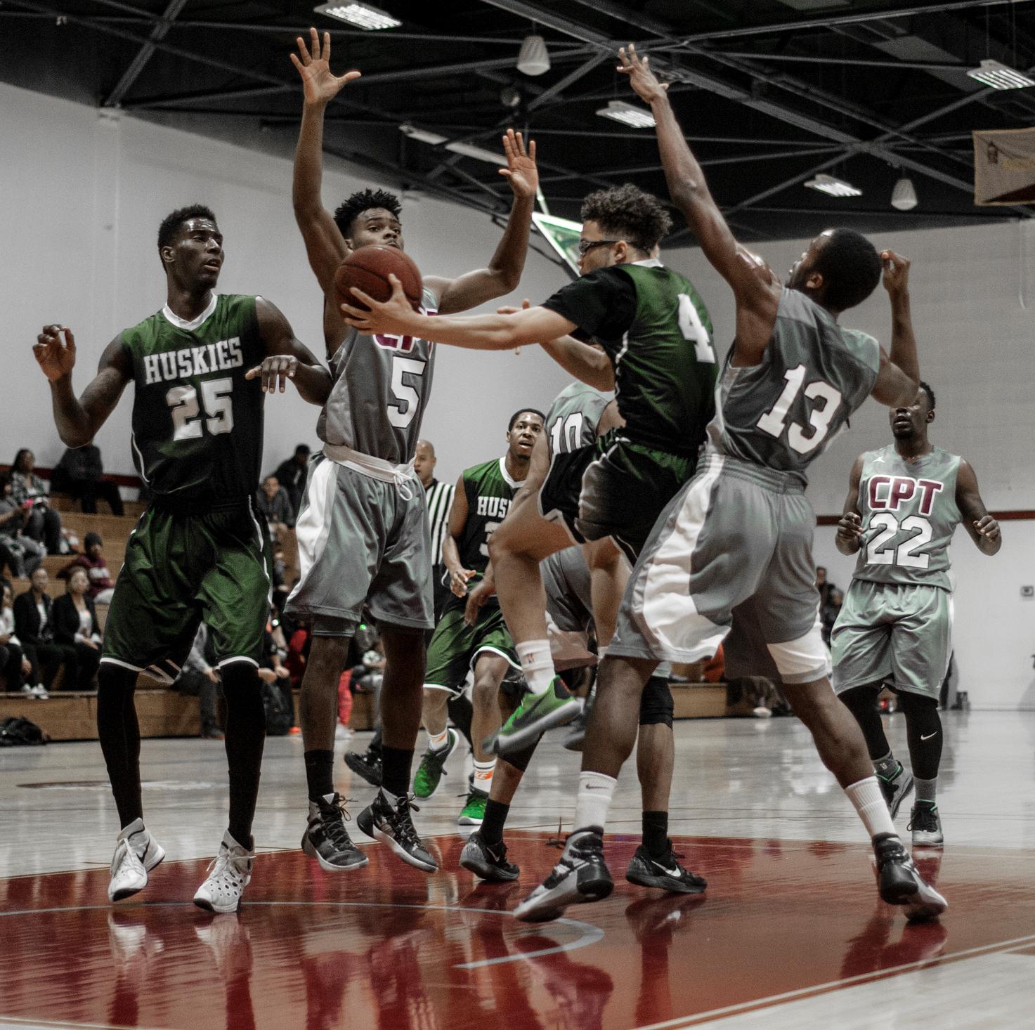 FOOLING AROUND&mdash;ELAC freshman guard Chandler Redix, No. 4, fools the Compton offense while air bound for a layup as he instead passes around a Tartar to sophomore forward Richard Bivens in a 93-86 Husky win. (Photo by Tadzio Garcia)