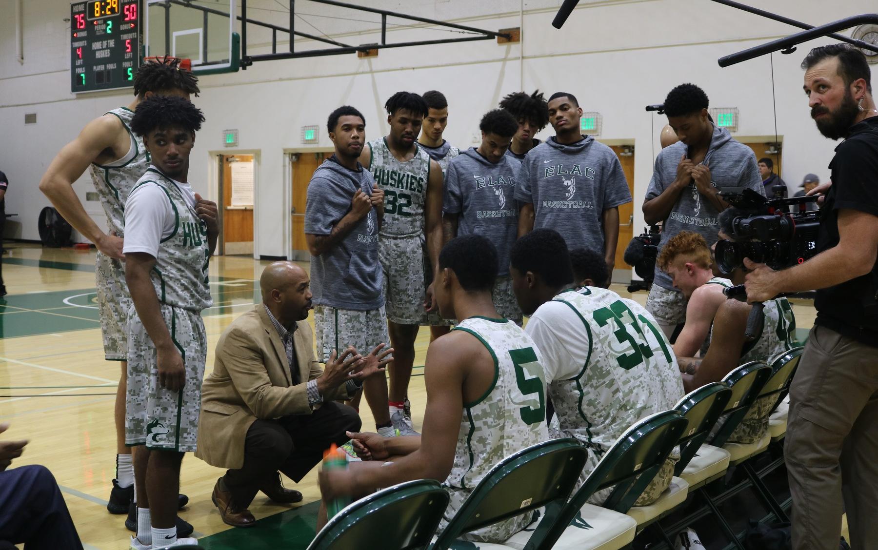 Coach Mosley during a timeout with the team (with Last Chance U cameras filming).