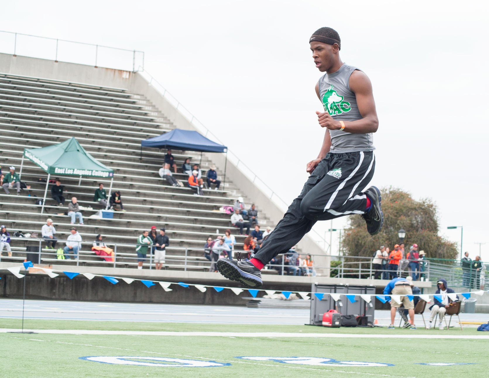 All-American East Los Angeles College sophomore Joshua Taylor, warming up in a previous year, wins the men's T&F long jump event at The Indoor Qualifier Meet at Soka University. (Photo by Tadzio Garcia)