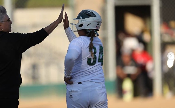 Melanie Torres hi-fives Asst Coach Angel after she knocks an RBI single.