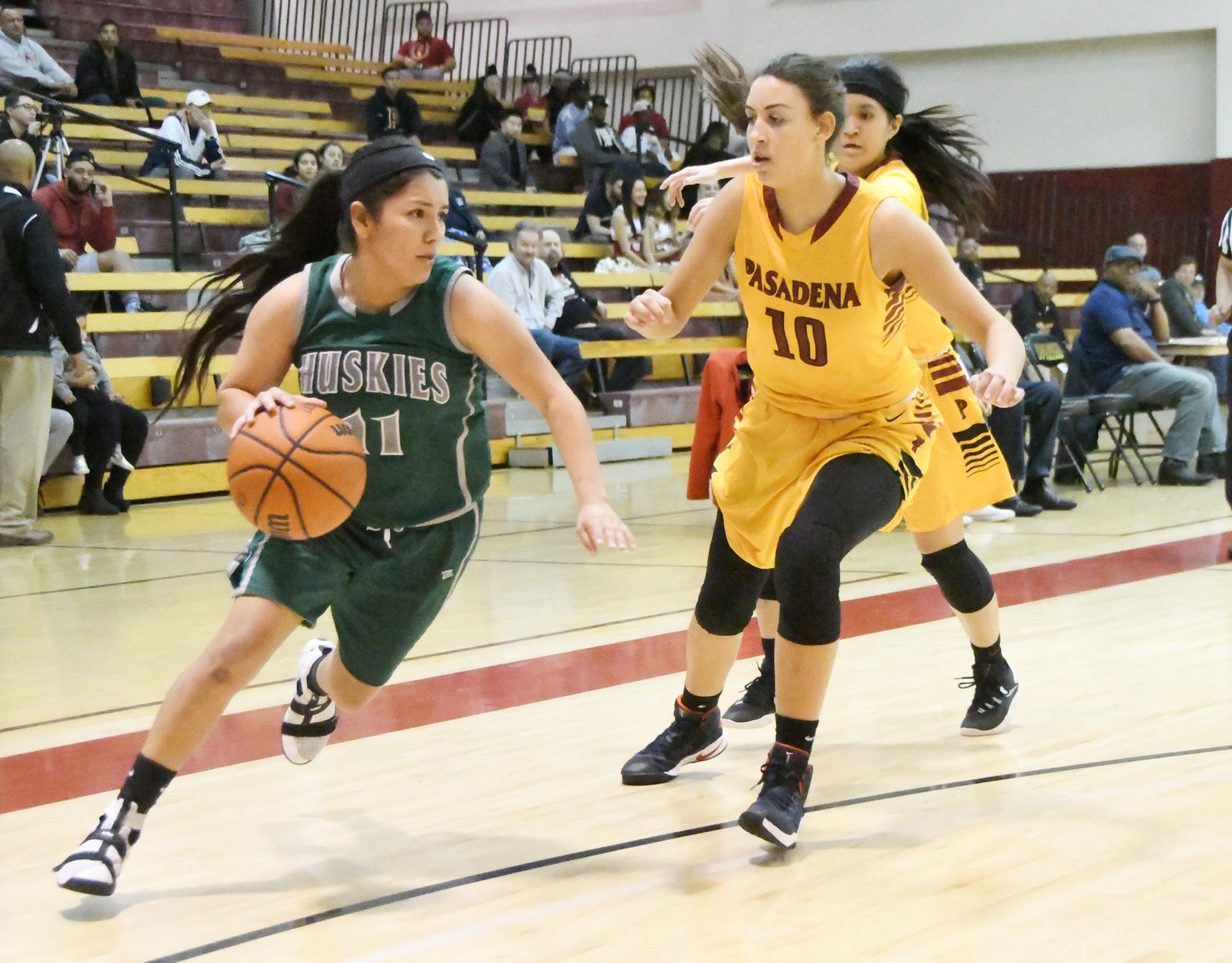 East Los Angeles College sophomore guard Tiffani Martinez moves into the paint around Pasadena City College sophomore guard Jolene Robinson in a 58-45 Husky win on Feb. 1. (Photo by DeeDee Jackson)