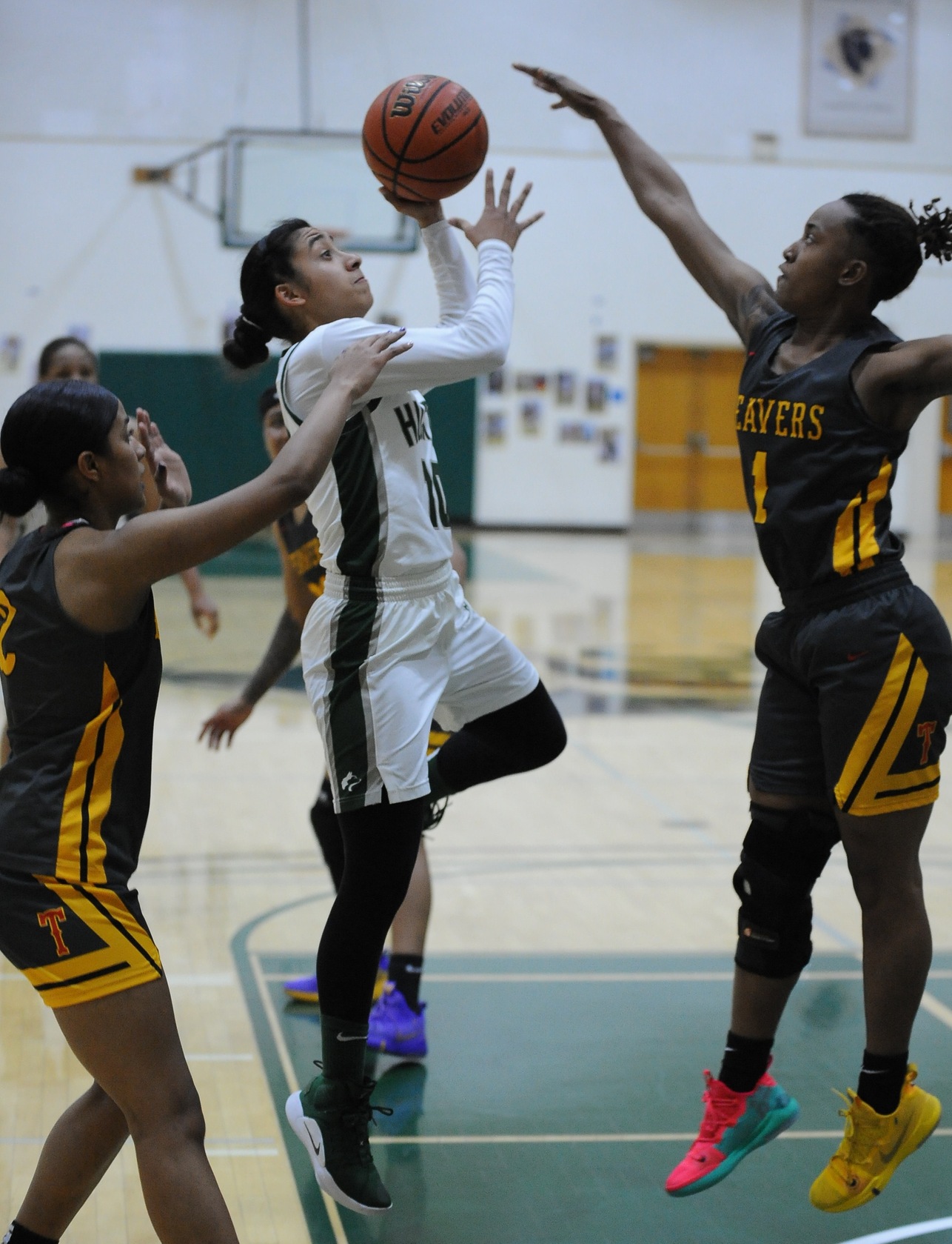 East Los Angeles College guard Jennifer Pool, left goes up to the basket in last Friday&rsquo;s game versus L.A. Trade Tech.